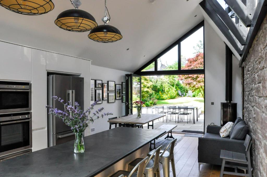 an open kitchen and dining room with a table and chairs at Cranford Holiday House in Crieff