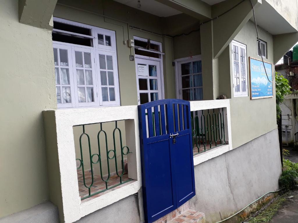 a blue door on the side of a house at Smriya Homestay in Darjeeling