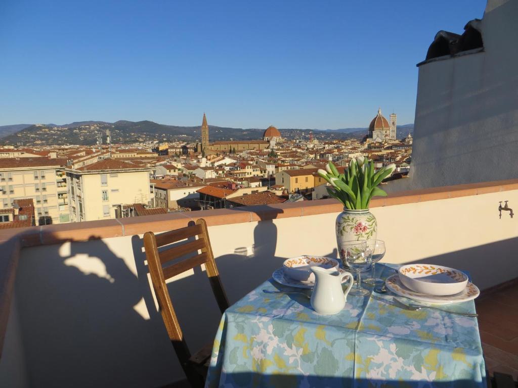 a table with a view of a city from a balcony at Appartamento Montebello in Florence