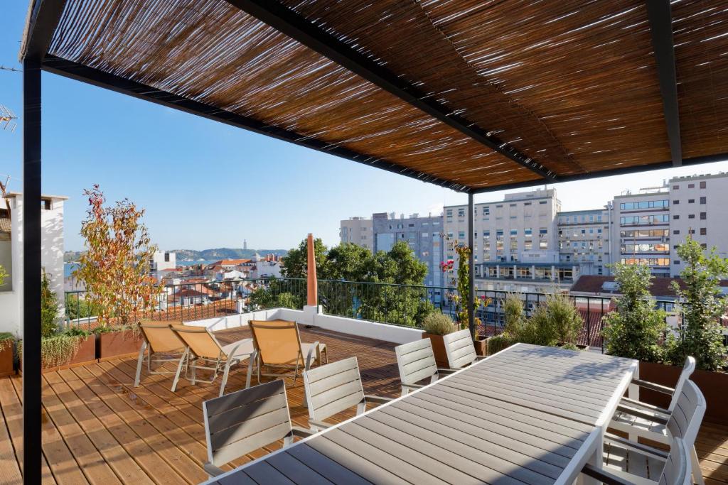 a patio with a table and chairs on a balcony at Boutique Chiado Duplex in Lisbon