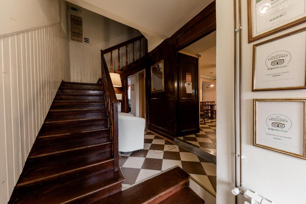 a hallway with a staircase and a checkered floor at Miracolo di Mare Retro in Piran