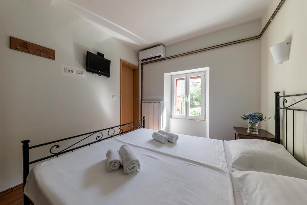 a bedroom with a bed with towels on it at Miracolo di Mare Retro in Piran
