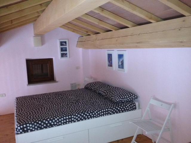 Postel nebo postele na pokoji v ubytování House in Montegridolfo