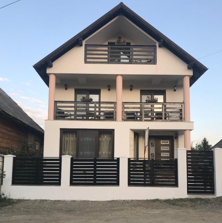 a house with balconies on top of it at Casa Bianca Oncesti in Onceşti