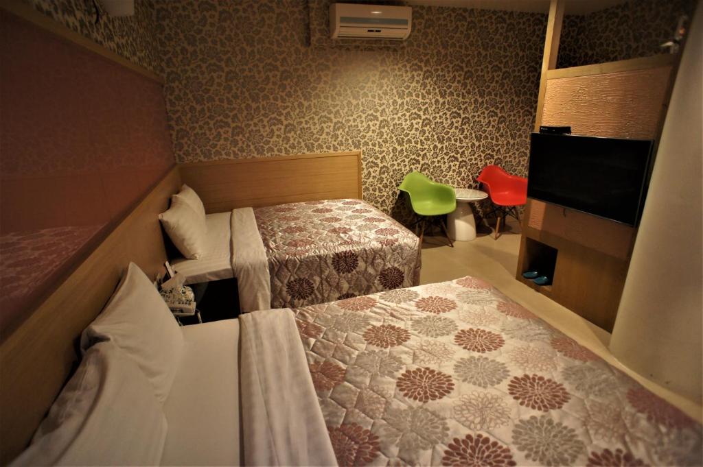 Postel nebo postele na pokoji v ubytování Xi Xin Guan Hot Spring Resort