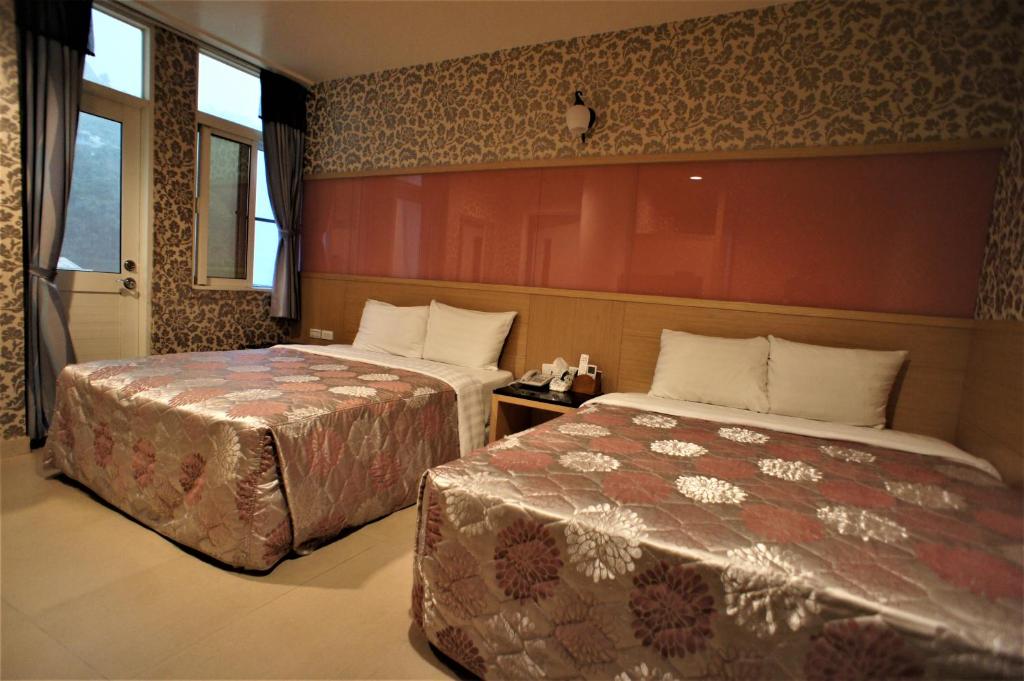 Postel nebo postele na pokoji v ubytování Xi Xin Guan Hot Spring Resort