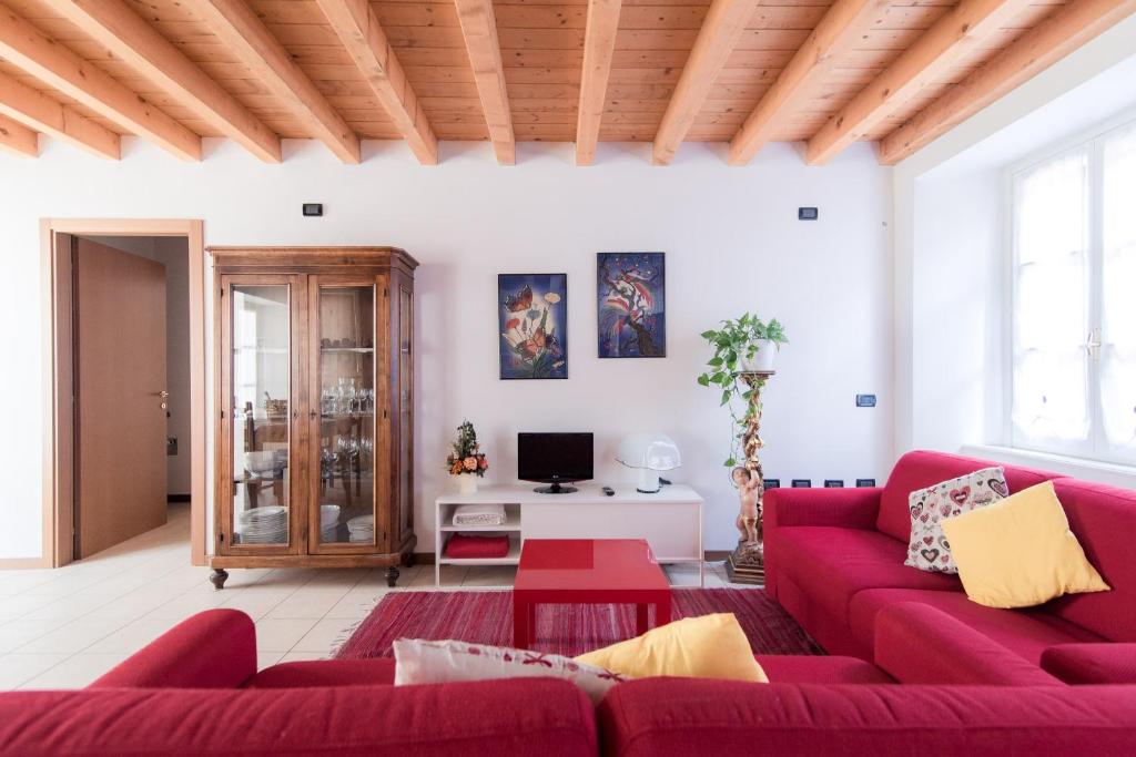 a living room with a red couch and a table at Ca Mia - The House Of Travelers in Como