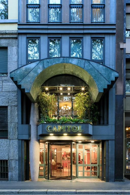 a building with an entrance to a store at Hotel Capitol Milano in Milan