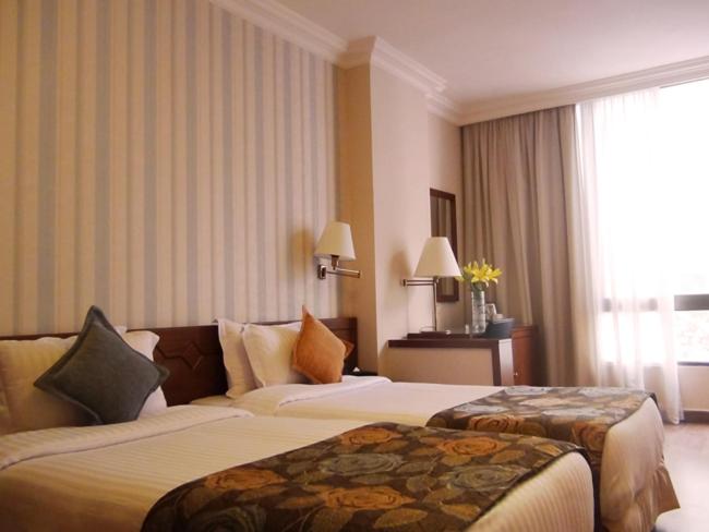 Postel nebo postele na pokoji v ubytování Orient Prince Hotel