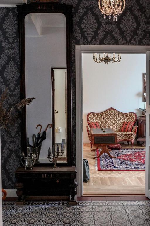 a living room with a mirror and a couch at Posti Apartment in Haapsalu