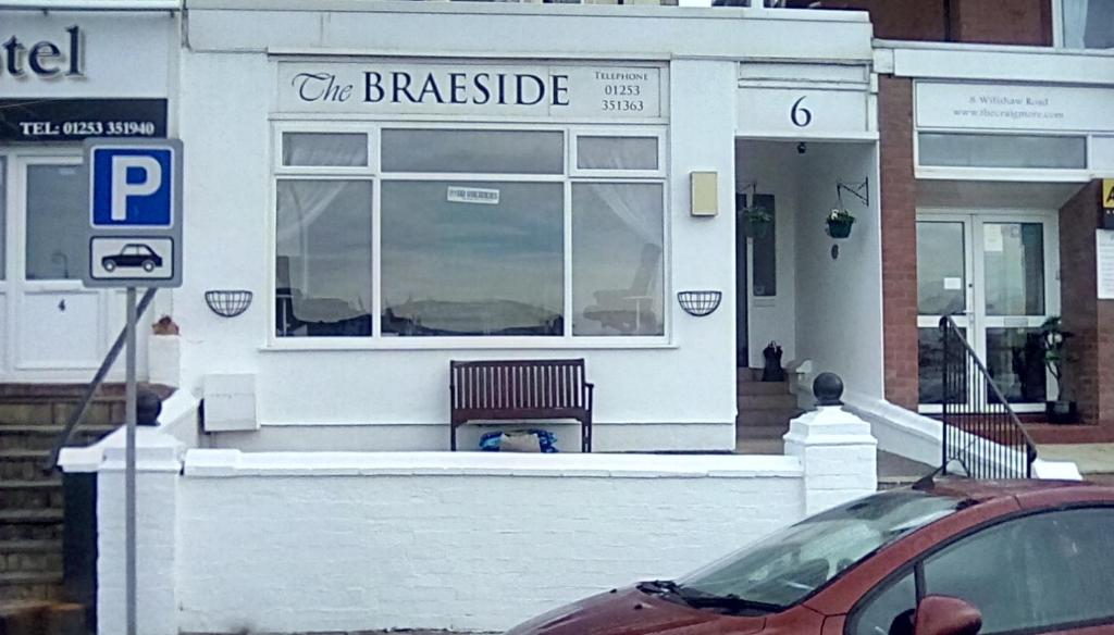 a car parked in front of a white building at The braeside families and couples in Blackpool