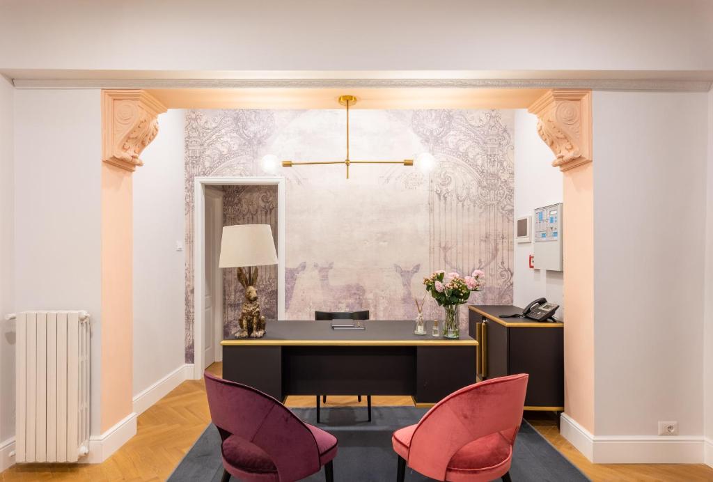an office with pink chairs and a desk in a room at 3110 ArtHotel in Florence
