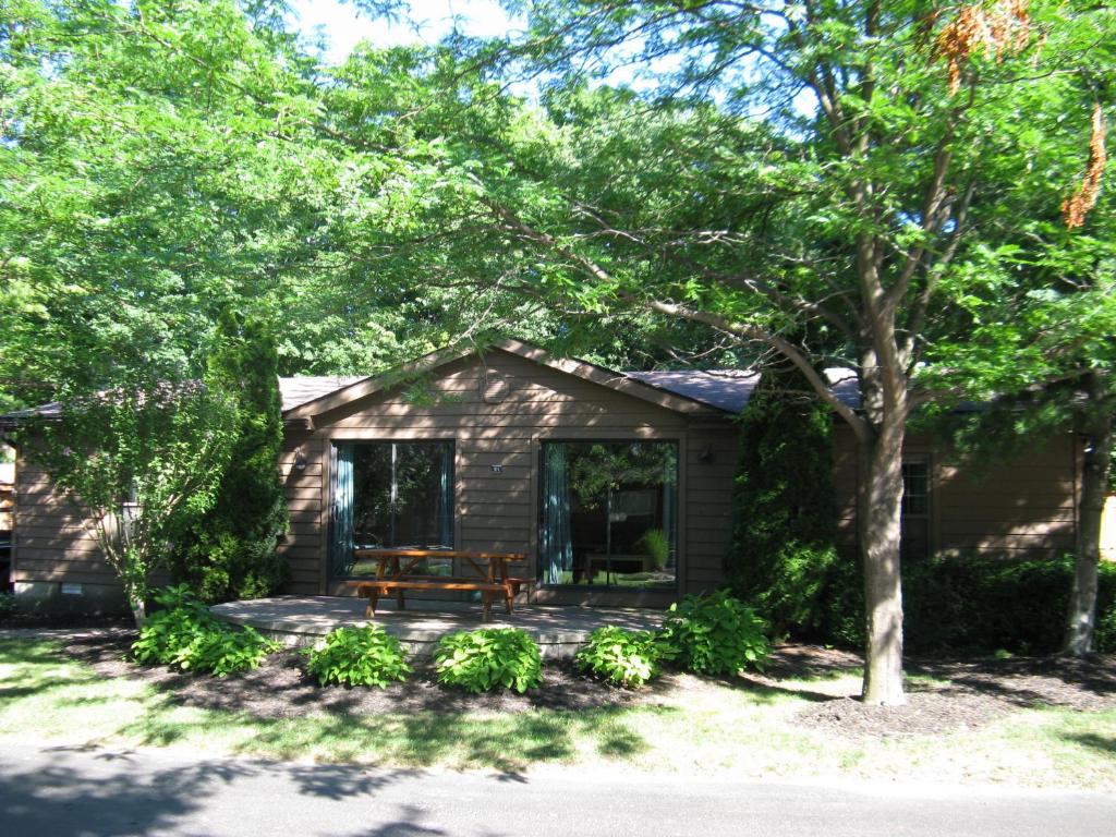 a small house with a picnic table on a patio at Island Club #104 in Put-in-Bay