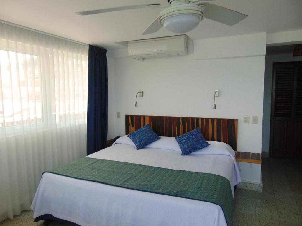 Postel nebo postele na pokoji v ubytování Hotel Rosita