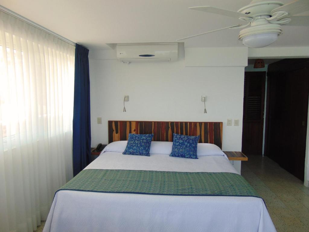 Postel nebo postele na pokoji v ubytování Hotel Rosita