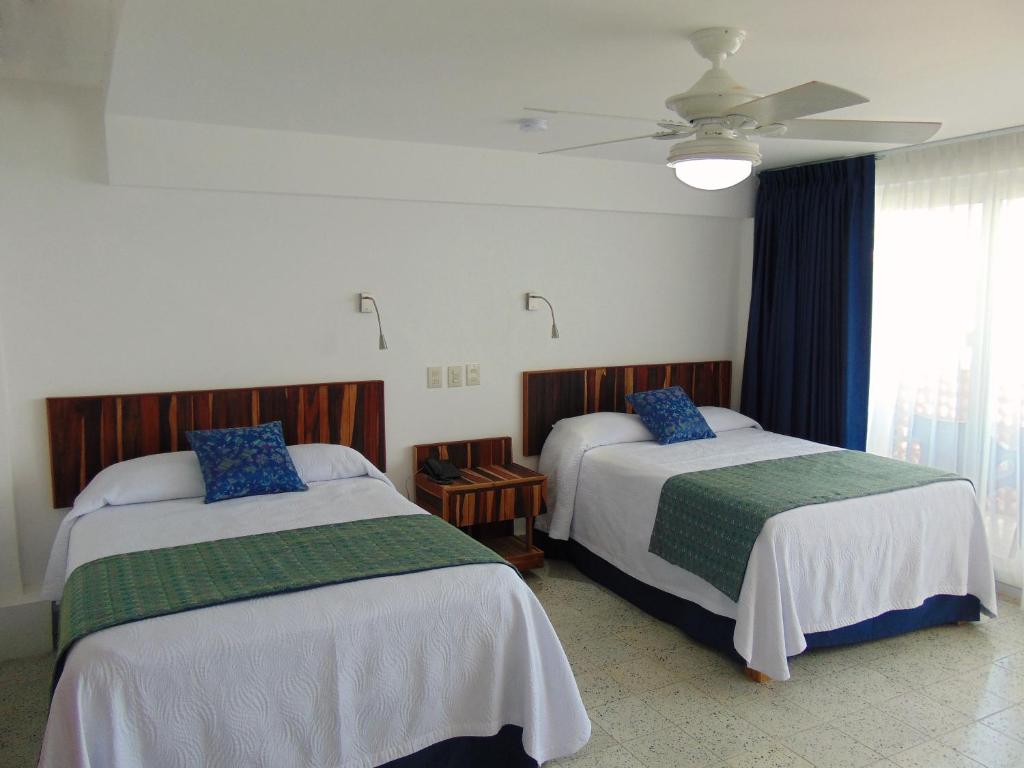 Postel nebo postele na pokoji v ubytování Hotel Rosita