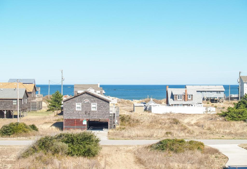 a group of houses on a hill near the ocean at Carolina Cottage in Kitty Hawk