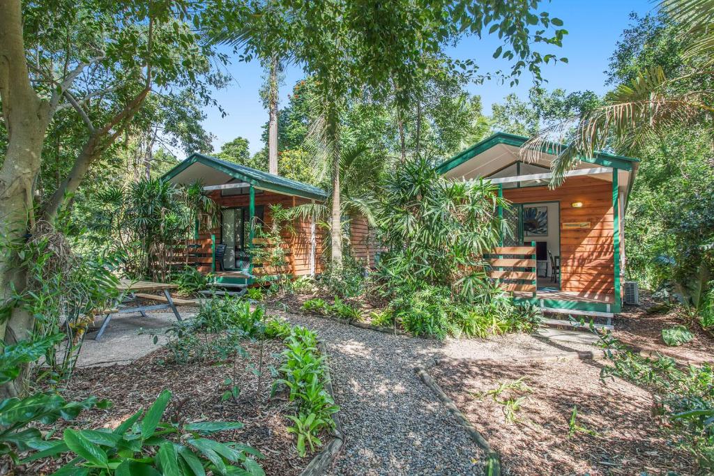 a house in the woods with a pathway leading to it at Ingenia Holidays Landsborough in Landsborough