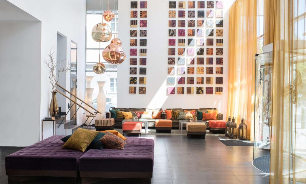 a living room with a purple couch in the middle at Best Western Plus Time Hotel in Stockholm
