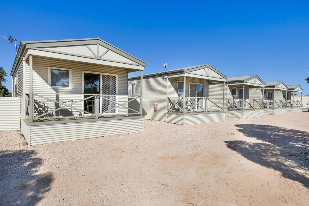 a row of modular homes on a dirt lot at Border Village Roadhouse in Border Village