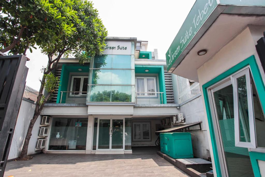 a building with a green and white facade at LeGreen Suite Tebet in Jakarta