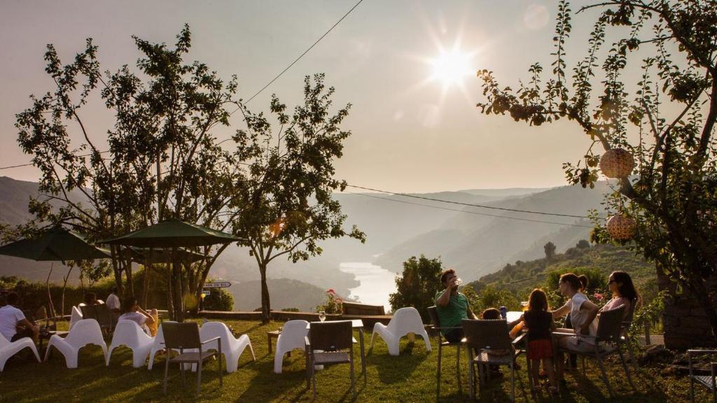 a group of people sitting at a table with a view at Casa Grande de Cristosende in Cristosende