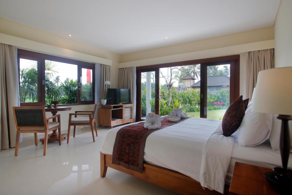 Postel nebo postele na pokoji v ubytování DLobong Suites Ubud