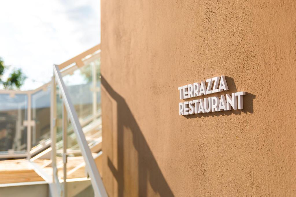 a sign on the side of a building that says temka restaurant at Torre Cintola Greenblu Sea Emotions in Monopoli