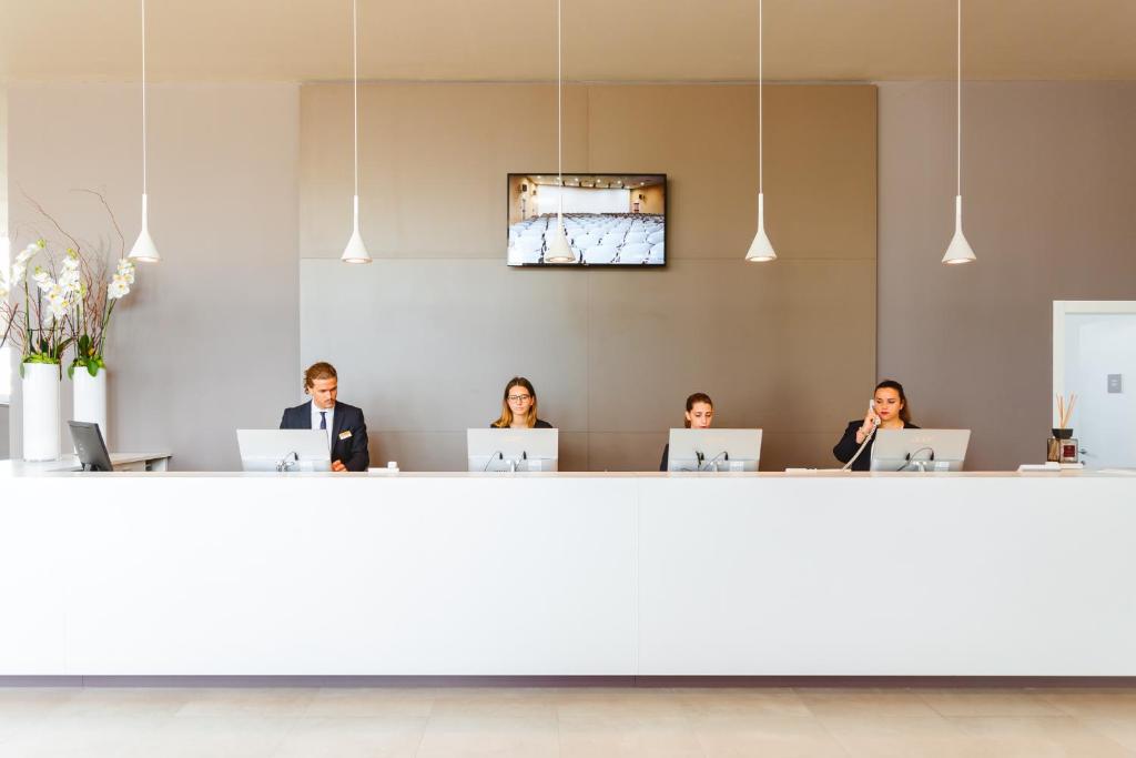 a group of people in a room with laptops at Torre Cintola Greenblu Sea Emotions in Monopoli