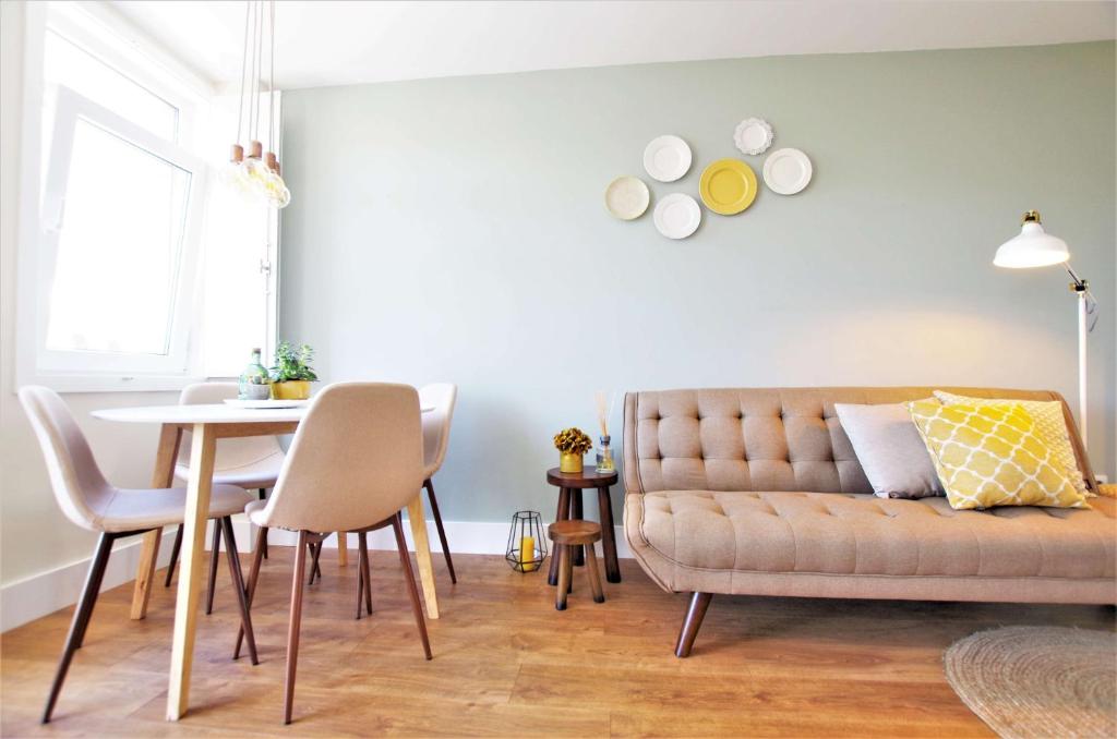 a living room with a couch and a table at Casas do Jardim in Marco de Canaveses