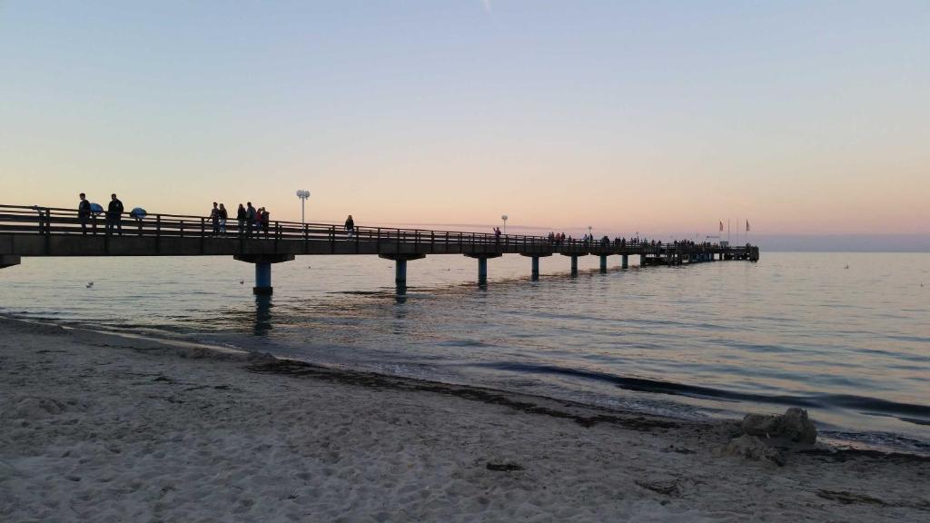 シャルボイツにあるPrivater Ostseeblickの水上桟橋を歩く人々