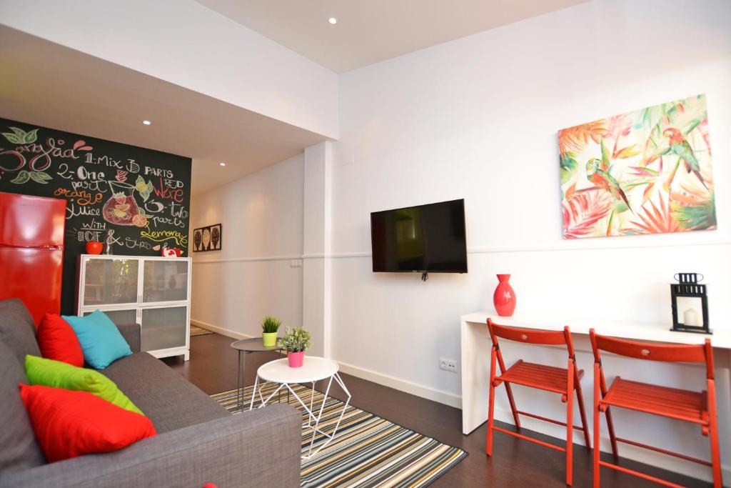 a living room with a couch and a table at Ático con terraza en el centro de Alicante in Alicante