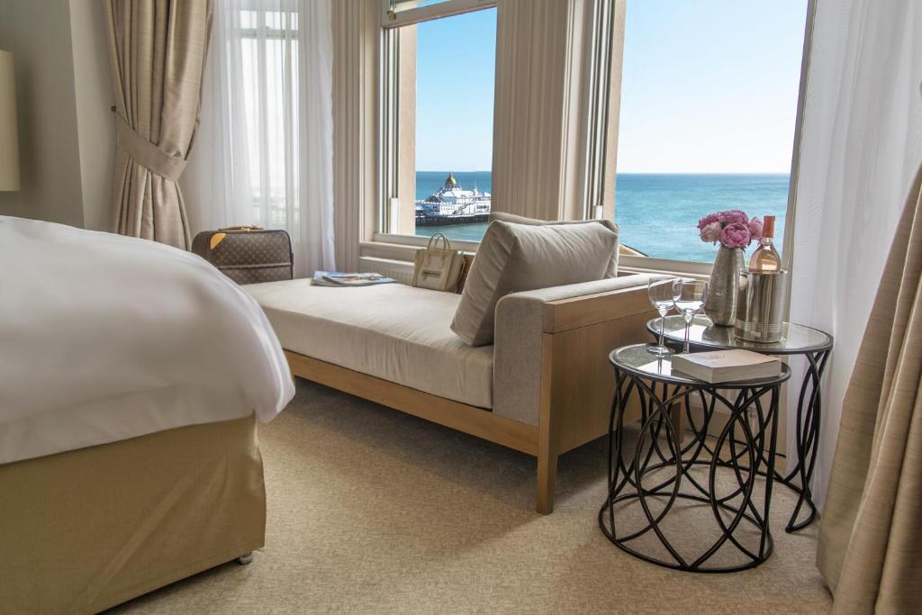 een hotelkamer met een bed en een groot raam bij The Chatsworth Hotel in Eastbourne