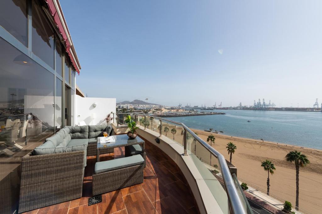 a balcony of a building with a view of the beach at Living Las Canteras Homes - PENTHOUSE FREE PARKING in Las Palmas de Gran Canaria