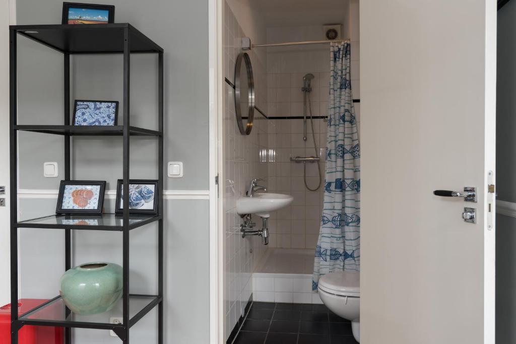 a bathroom with a toilet and a sink at Westerpark Home in Amsterdam