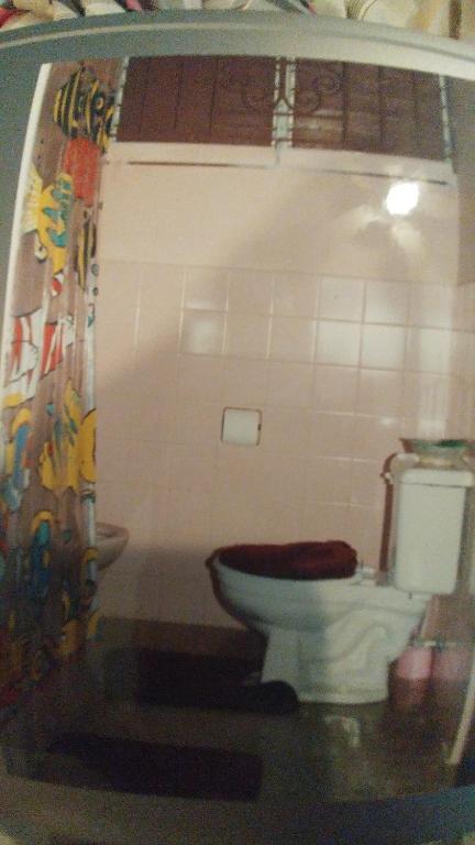 a bathroom with a toilet and a sink at Belretiro Cottage in Ocho Rios