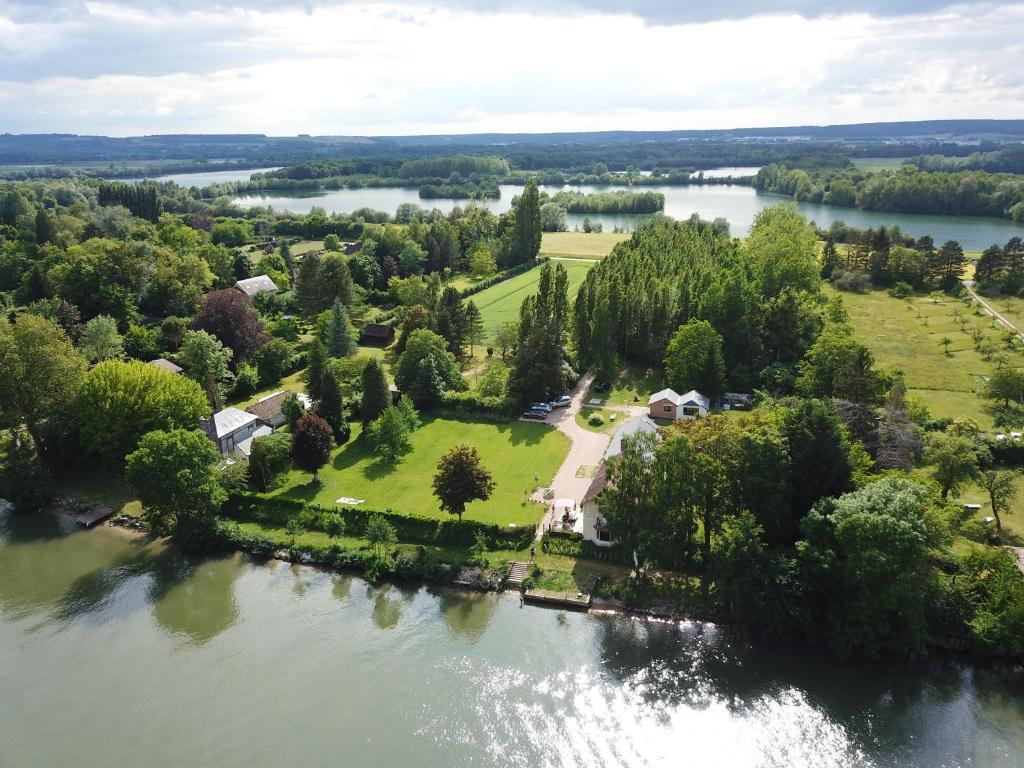 an aerial view of a house on an island in a river at Clairseine in Tournedos-sur-Seine