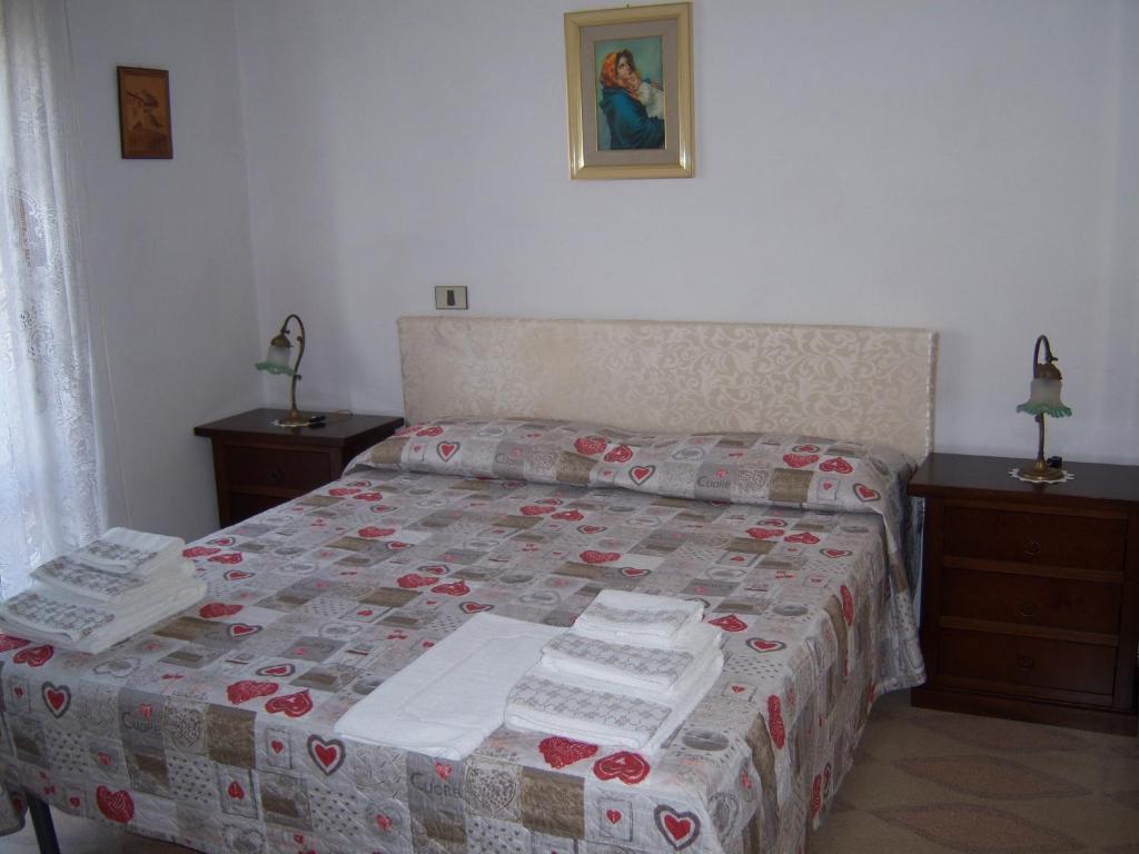 a bedroom with a bed with a quilt on it at Affittacamere Mariada in Torre Melissa