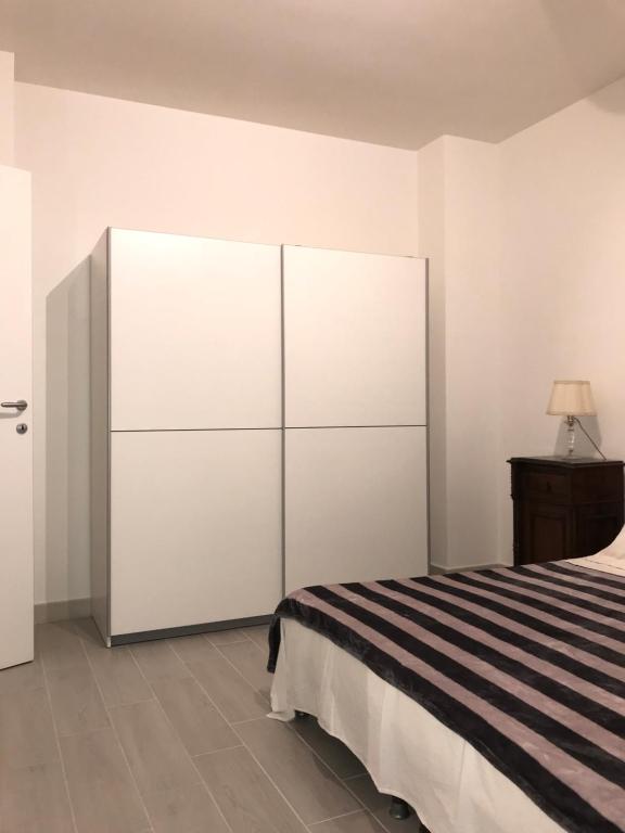a bedroom with a bed and a large white closet at Bari Lory’s Home in Bari