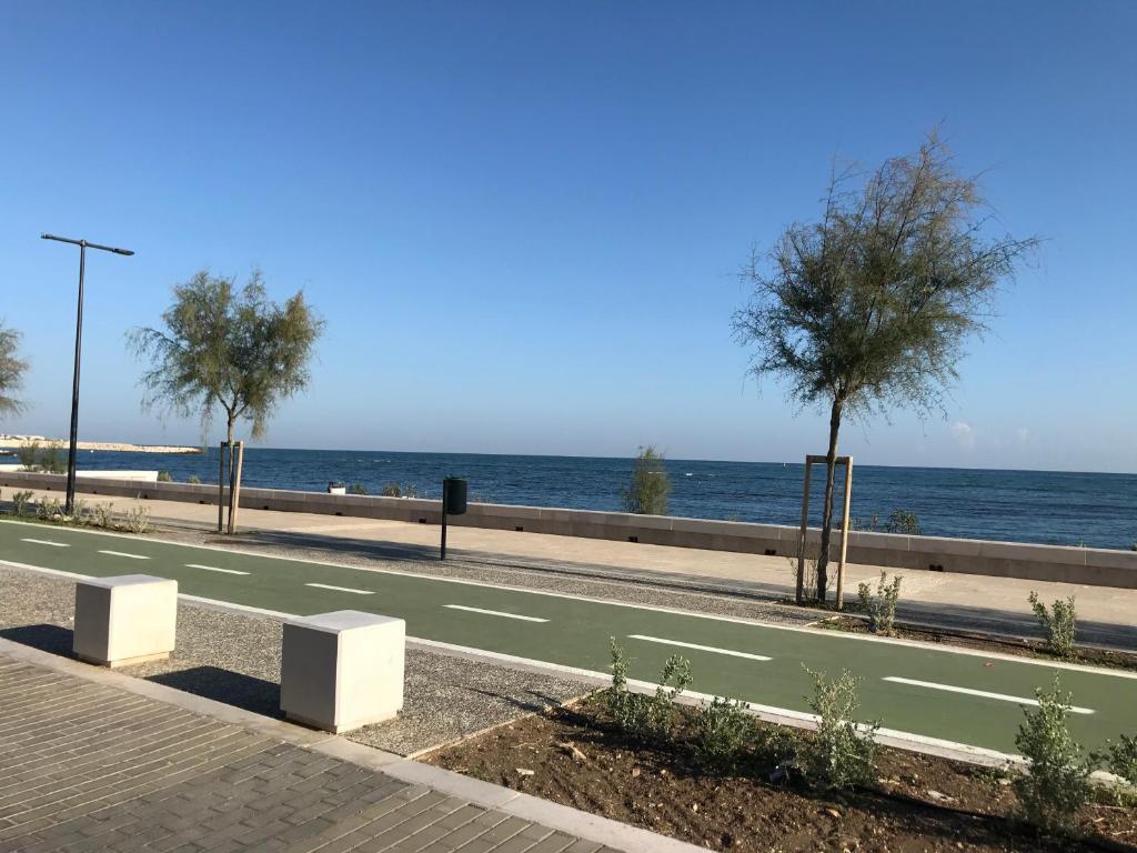 a road with trees on it next to the ocean at Bari Lory’s Home in Bari