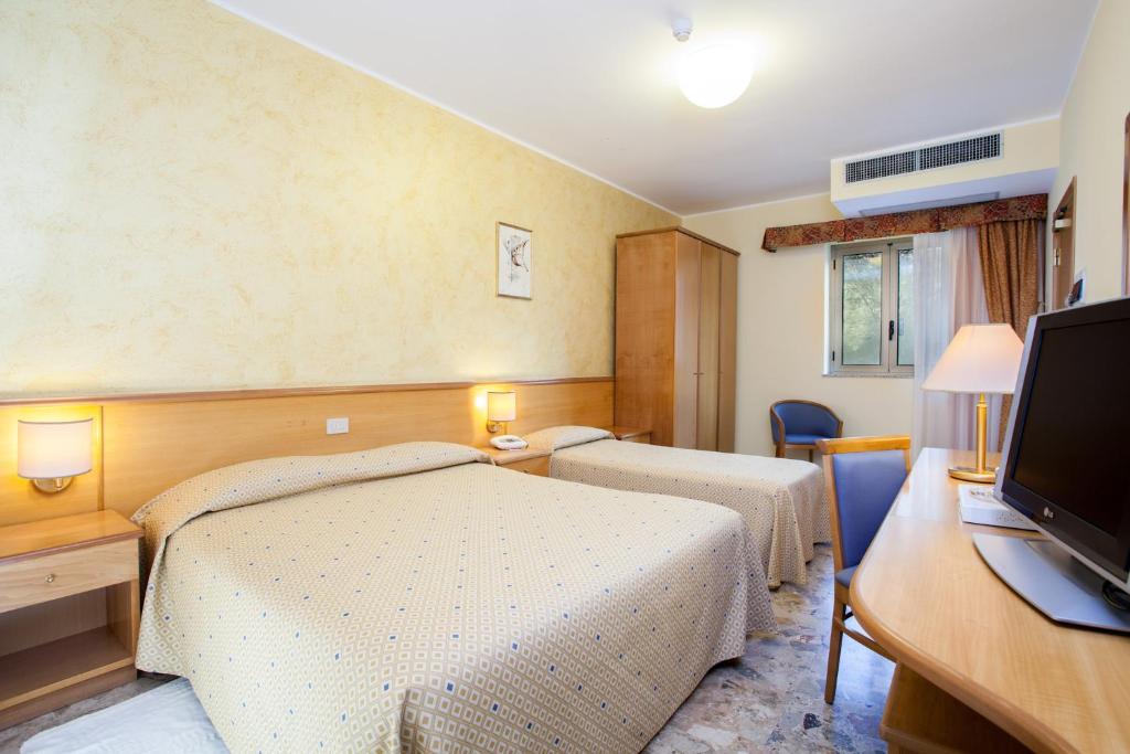 Postel nebo postele na pokoji v ubytování Hotel La Tonnara