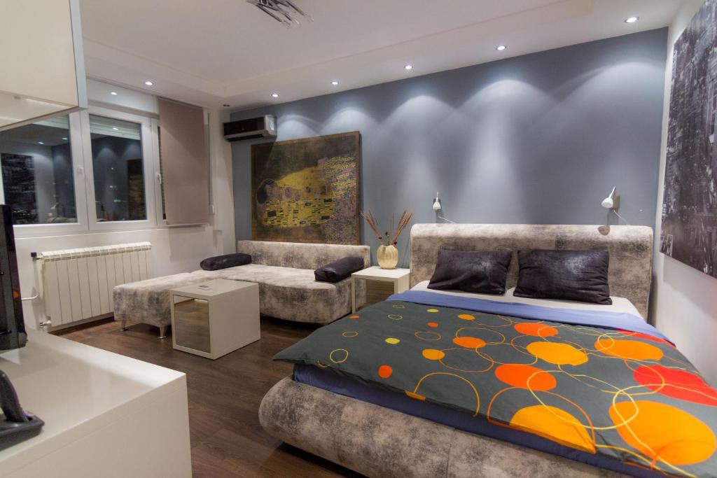 a bedroom with a bed and a couch at Central Park Apartments in Belgrade
