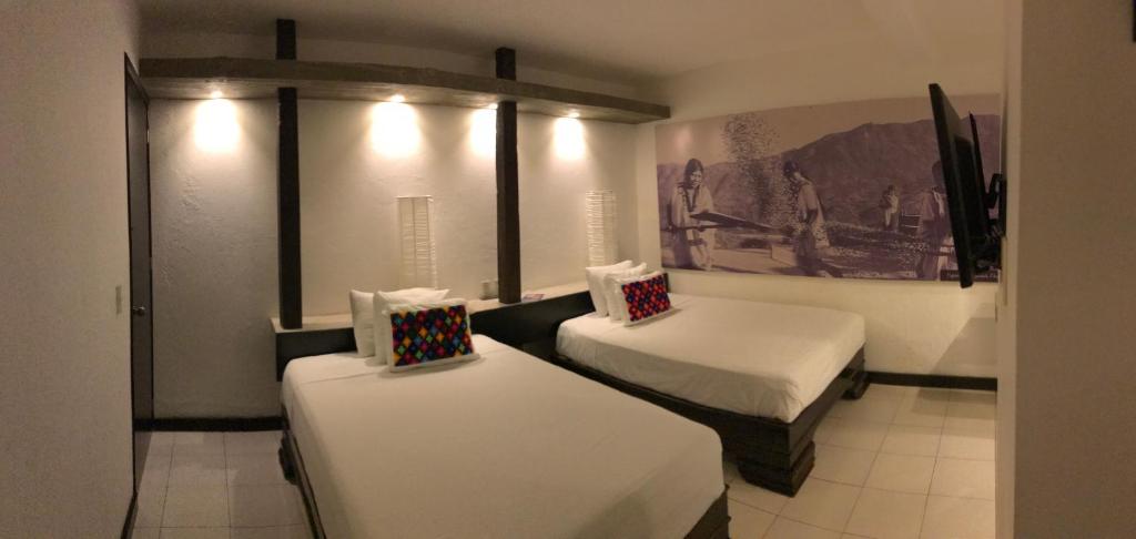 Postel nebo postele na pokoji v ubytování Hotel Maya Rue