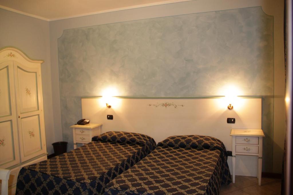 Postel nebo postele na pokoji v ubytování Albergo La Piana