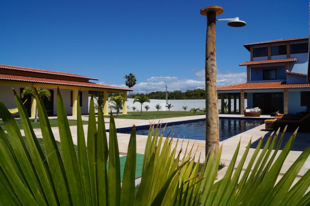 a resort with a swimming pool and a house at Casas Ipanema in Parajuru
