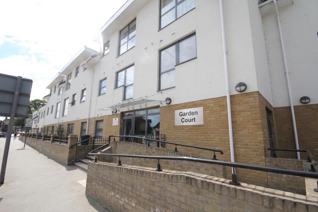 a building with a sign for a certain court at Garden Court in West Drayton