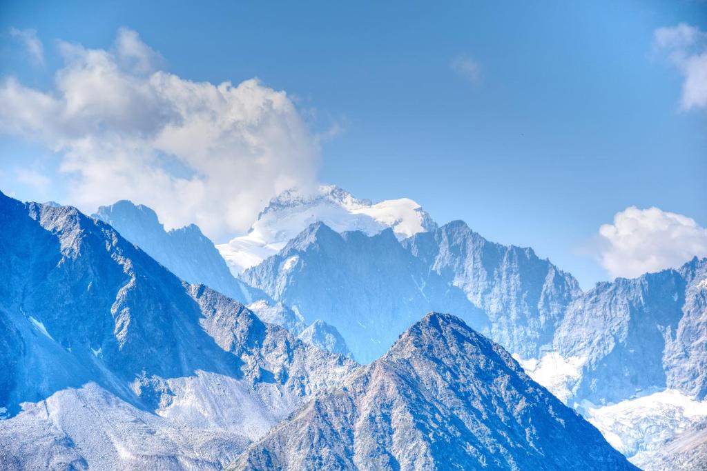 a view of a mountain range with snow capped mountains at Rock Noir & Spa in La Salle-les-Alpes
