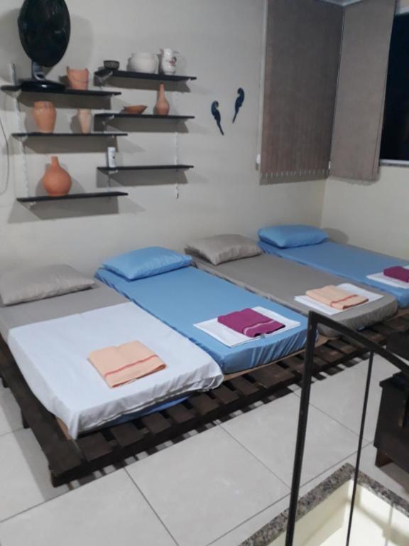 a room with three beds on the floor at Sótão Oktoberfest in Blumenau