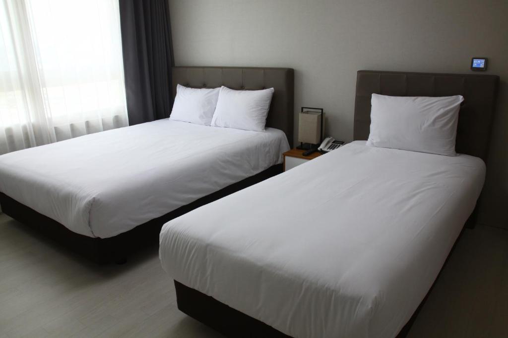 Postel nebo postele na pokoji v ubytování AM Hotel