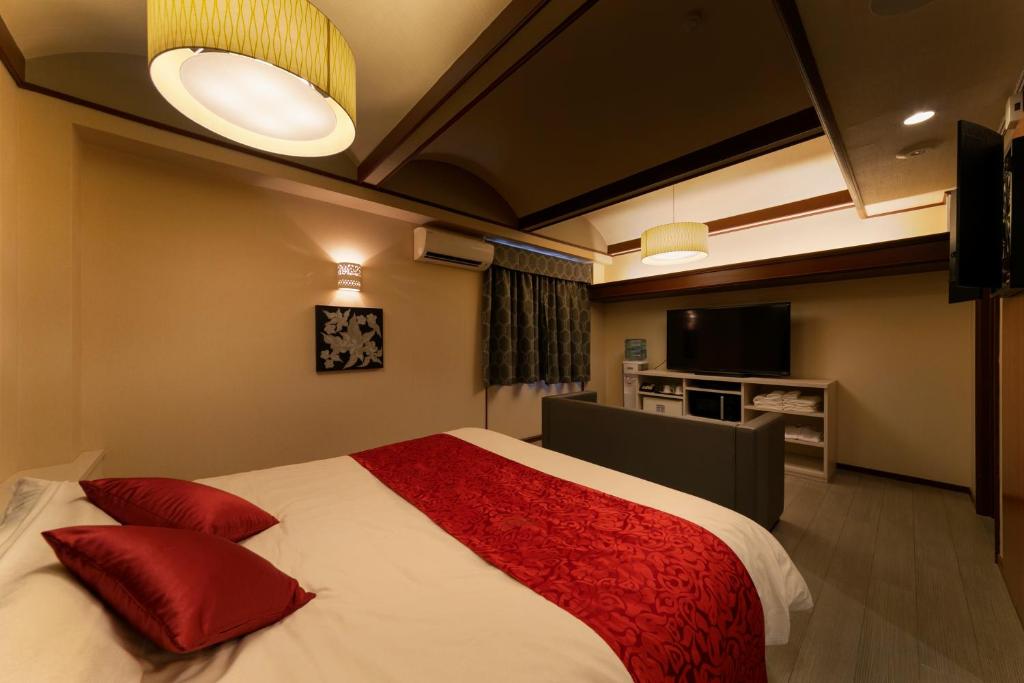 Postel nebo postele na pokoji v ubytování Hotel Lotus Sakai (Adult Only)